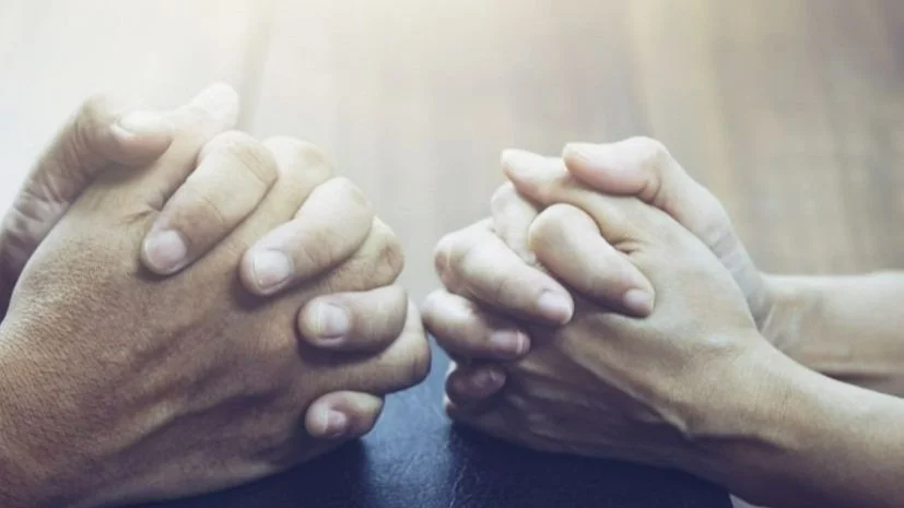 Hands clasped in prayer